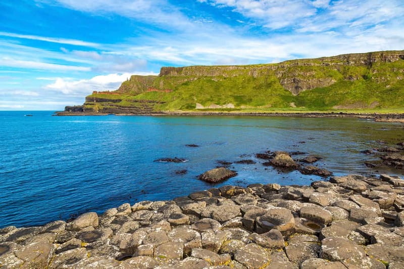 From Belfast: Giant's Causeway and Game of Thrones Tour - Dunluce Castle, a dramatic ruin above the sea